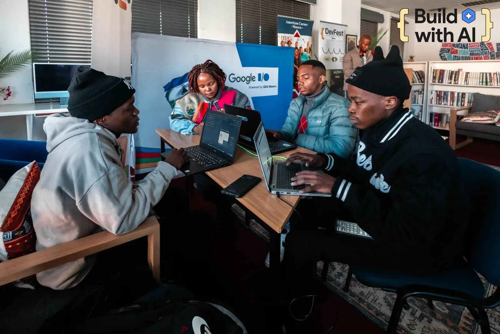 Build with AI participants collaborating at laptops during a hands-on session in Maseru