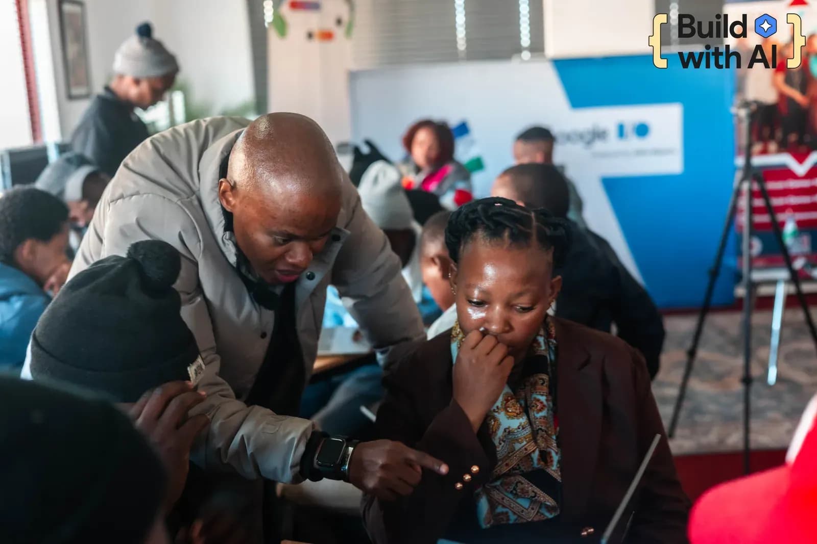 A facilitator supporting participants during a Build with AI learning session